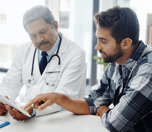 Patient reviewing a list of questions with their doctor